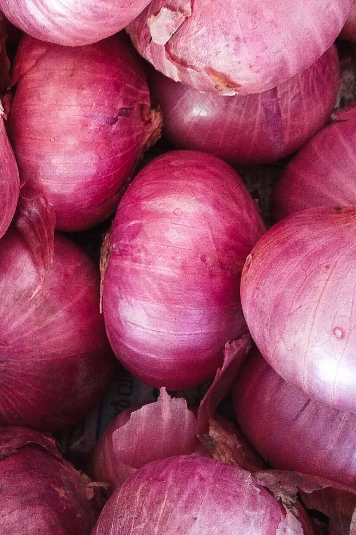 A bunch of pink onions from above.