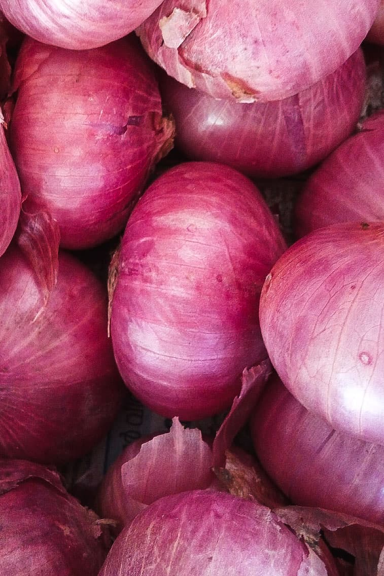 A bunch of pink onions from above.