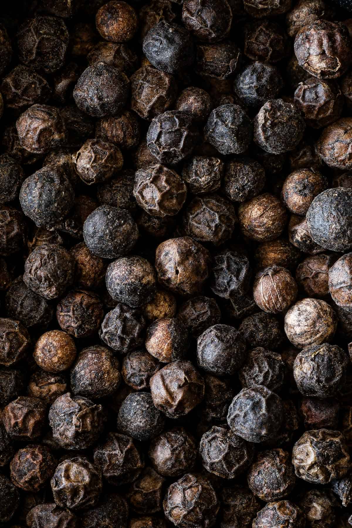 Black peppercorns close up.