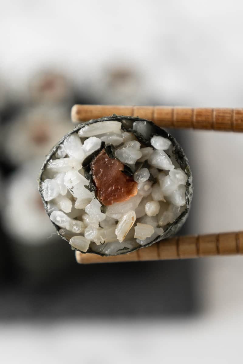 https://thefruityjem.com/wp-content/uploads/2023/06/chopsticks-holding-umeshiso-sushi-from-the-right.jpg