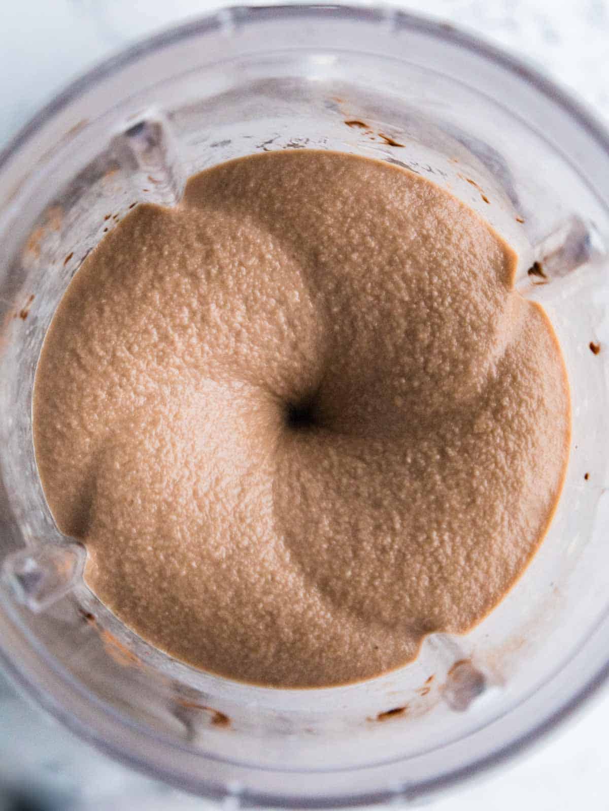 Blended Nutella milkshake without ice cream in a blender, taken from above.