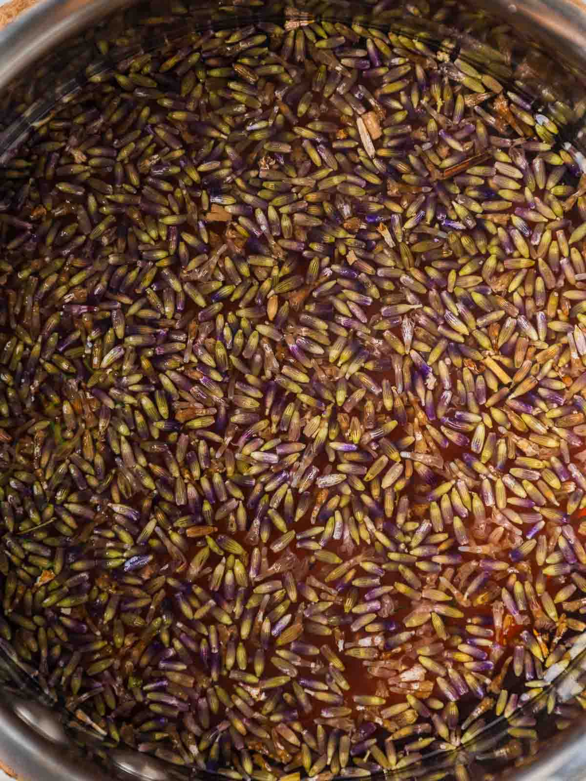 Boiling lavender with apple juice and water in a saucepan.