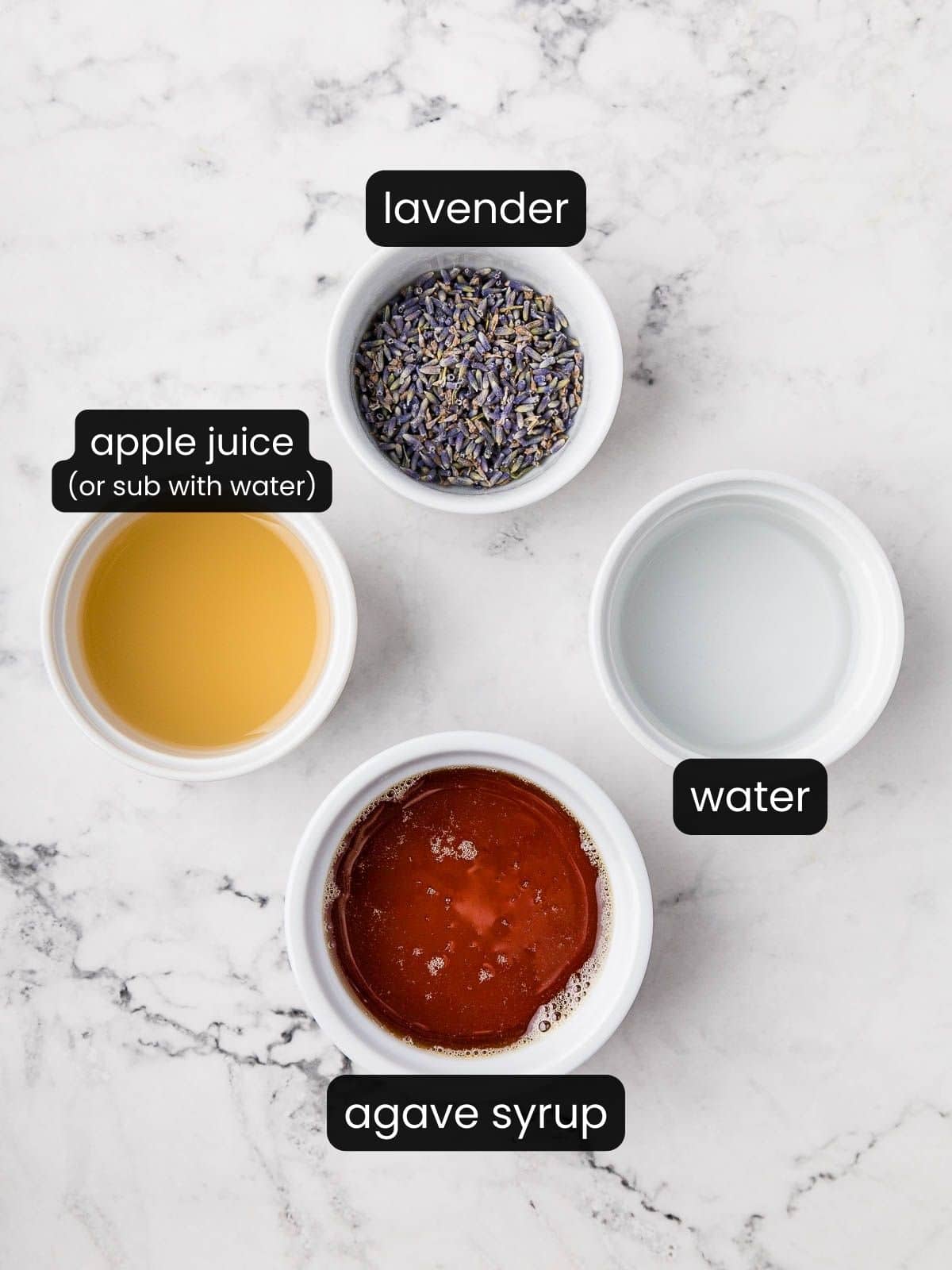 Dried lavender bulbs, apple juice, agave syrup, and water in small white bowls.