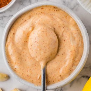 Spicy garlic aioli mayonnaise sauce with a spoon.