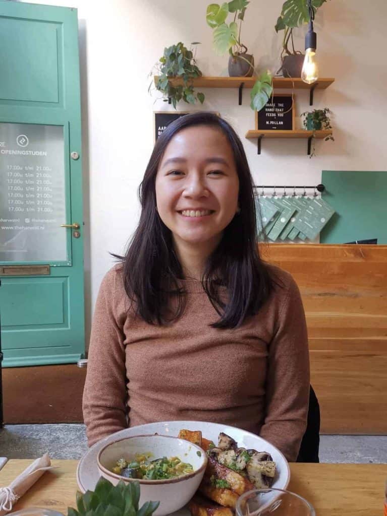 Jem Mantiri in a vegan restaurant with green and brown color theme.