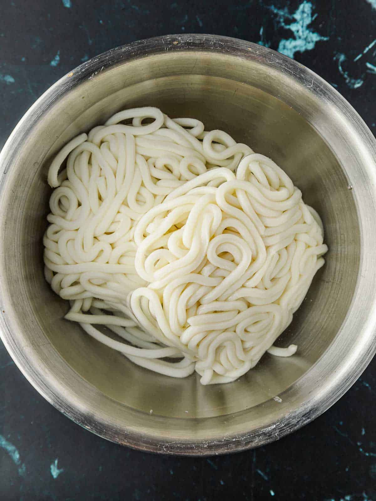 Packed udon noodles fresh from the package, before they loosen up.