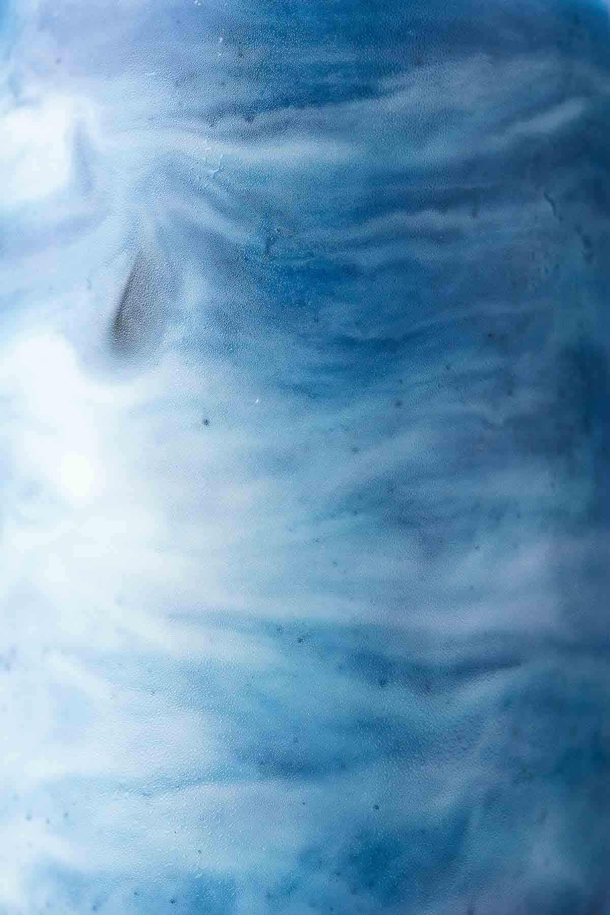 Close-up of a beautiful marbled look of blue butterfly pea latte.