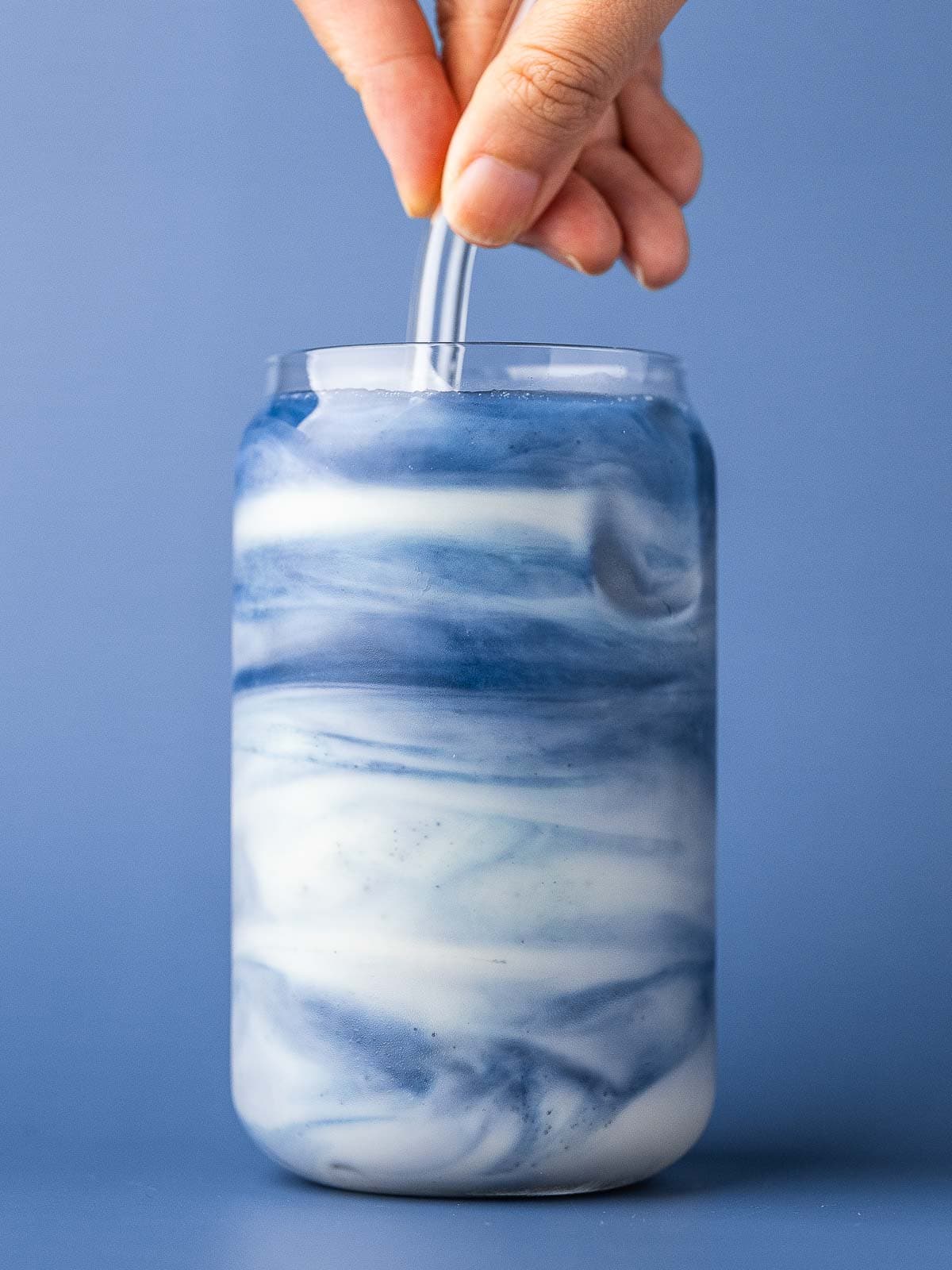 Stirring the blue mermaid latte to create a pretty marbled look.